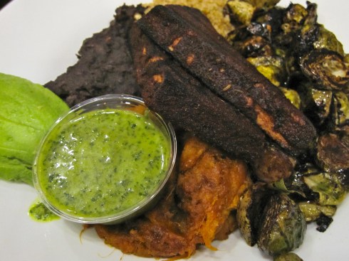 Seasoned quinoa, black beans, charred balsamic brussels, mashed sweet potatoes, spicy blackened tofu with chimichurri sauce, and avocado slices,