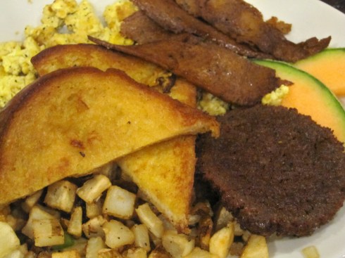 2 French toast wedges, scrambled tofu, potato hash, seitan sausaeg, seitan bacun & fruit garnish,