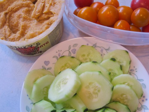 Smoked Tomato & Basil Hummus with cucumbers and cherry tomatoes.