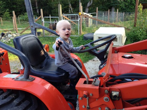 Playing on the tractor at New Moon Farm - August 3, 2016